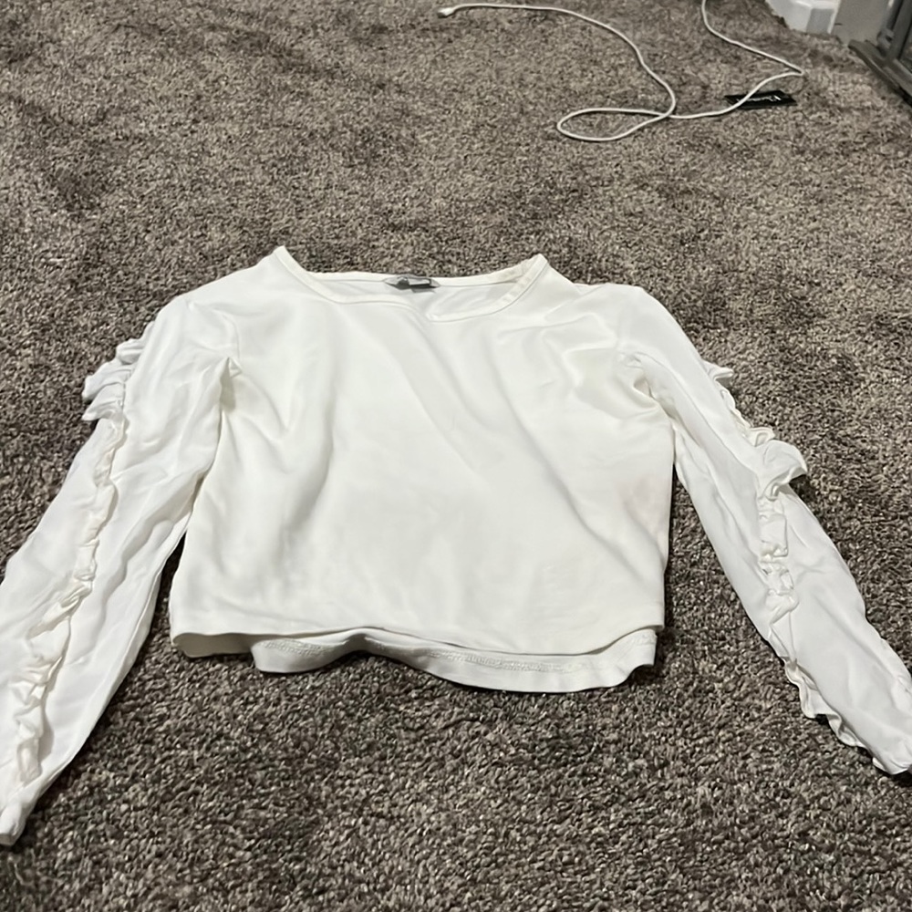 White shirt with ruffles on the sides